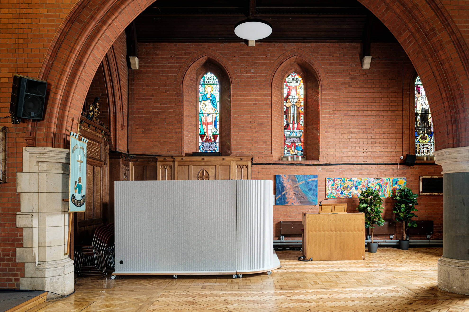 Partitioning hides unsightly stacked chairs in a church nave