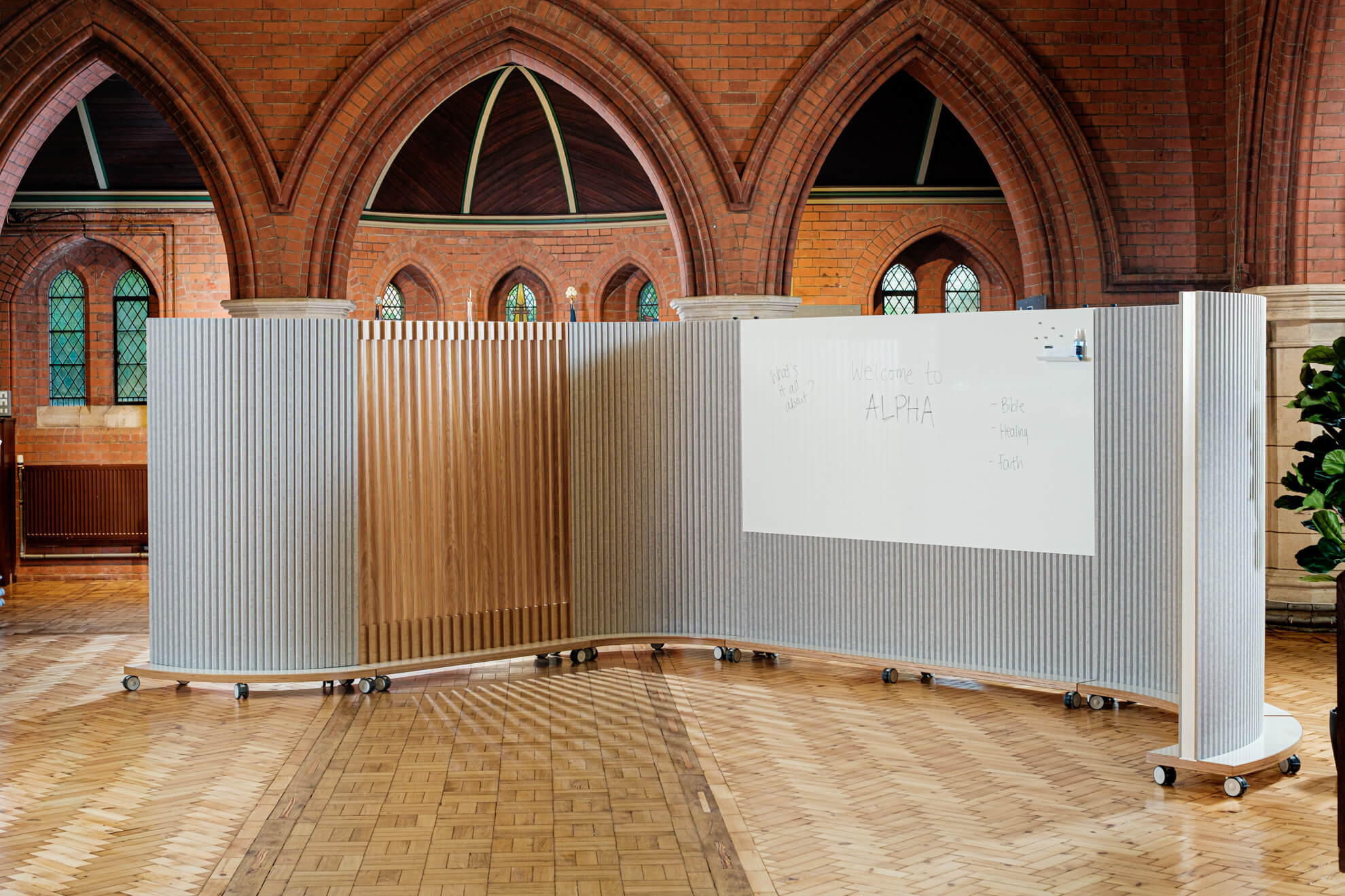 Partitioning including a magnetic drywipe whiteboard creates a small and welcoming space in a church nave